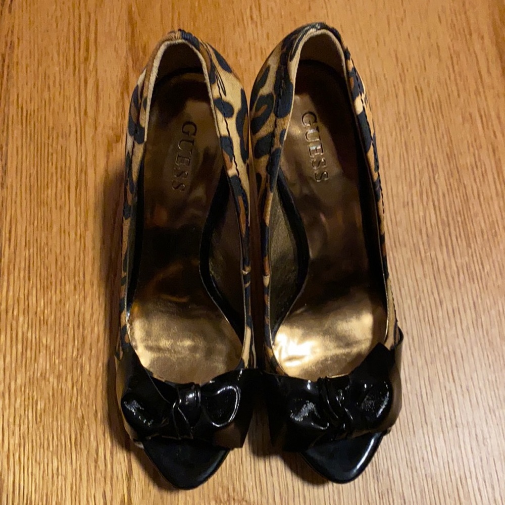 Leopard and patent leather peep toe with a bow.